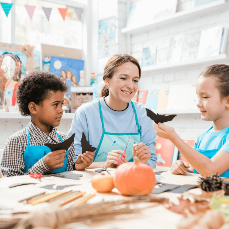 a teacher making Halloween gifts with students