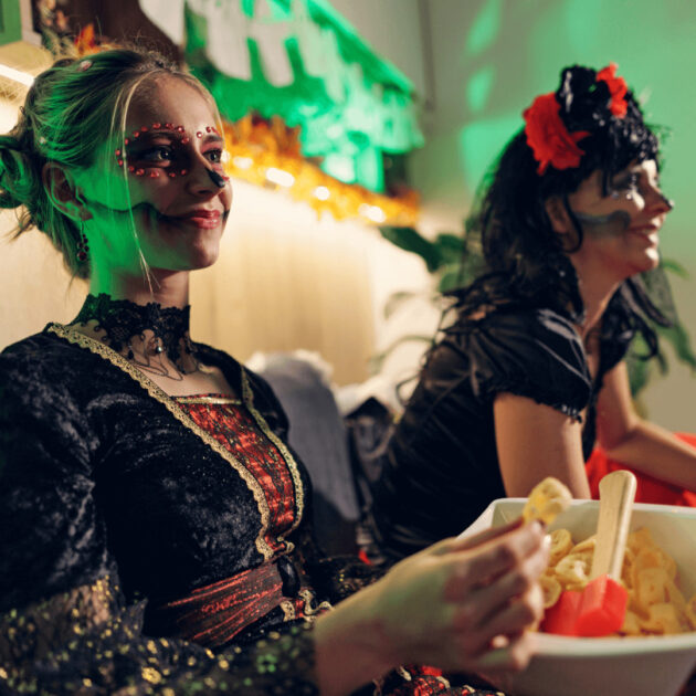 Party guests watching a Halloween movie