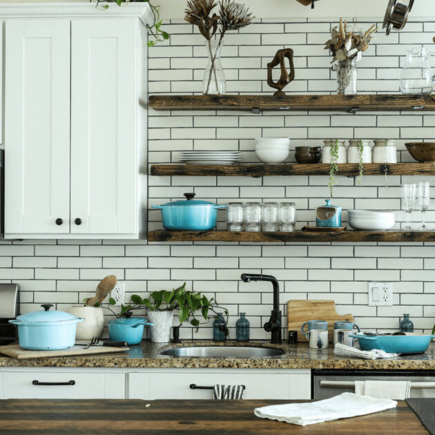 wooden floating shelves with white backsplash