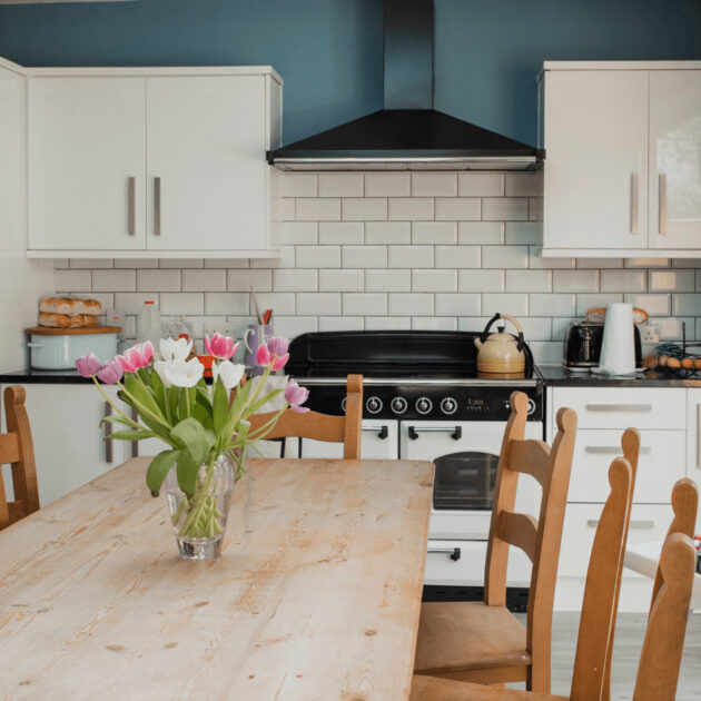 a blue and white kitchen with a blue accent wall
