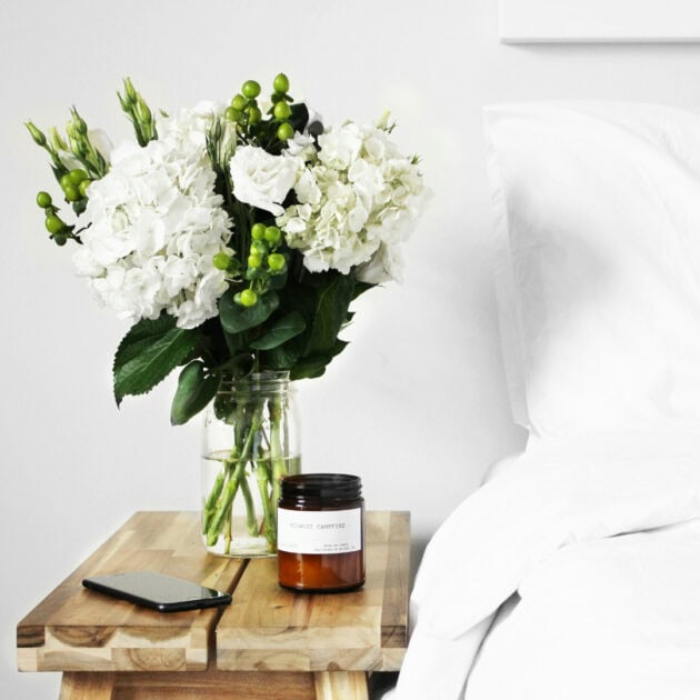 a flower vase on a rustic side table