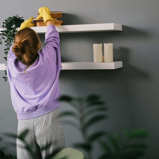 a woman decluttering her living room