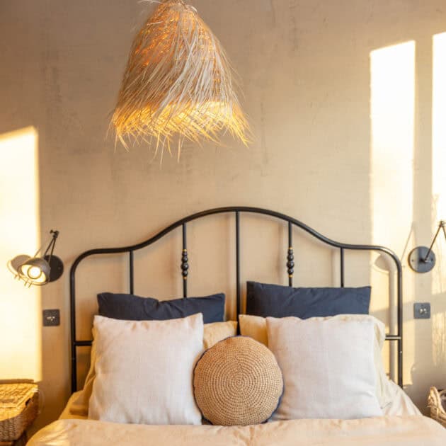a minimalist bedroom with earth tone bedding