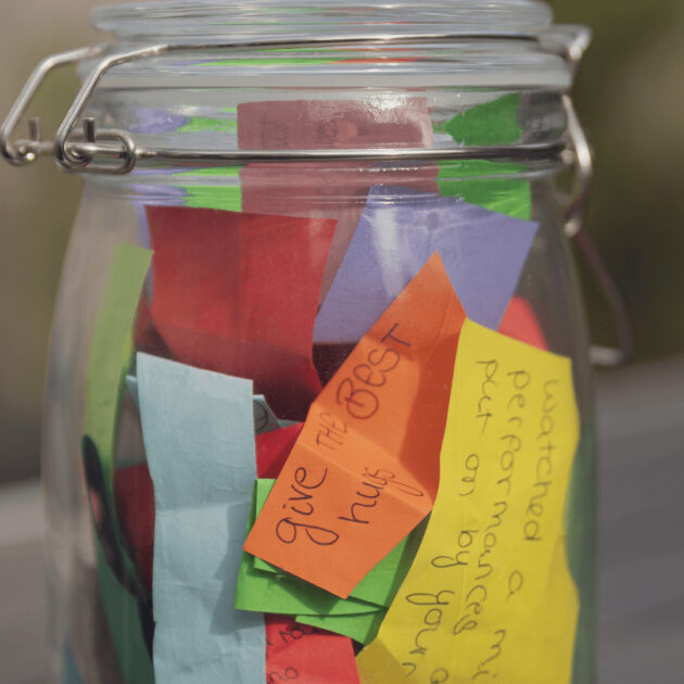 Gratitude statements on a piece of paper in a gratitude jar