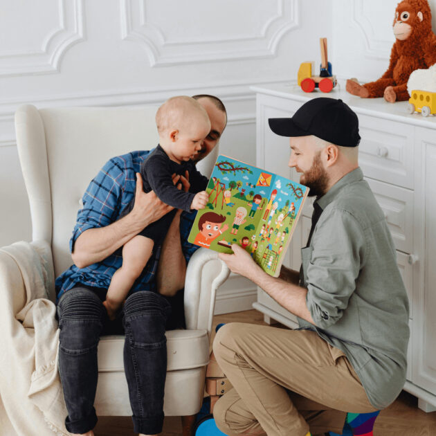 kid and dads reading a book in the living room
