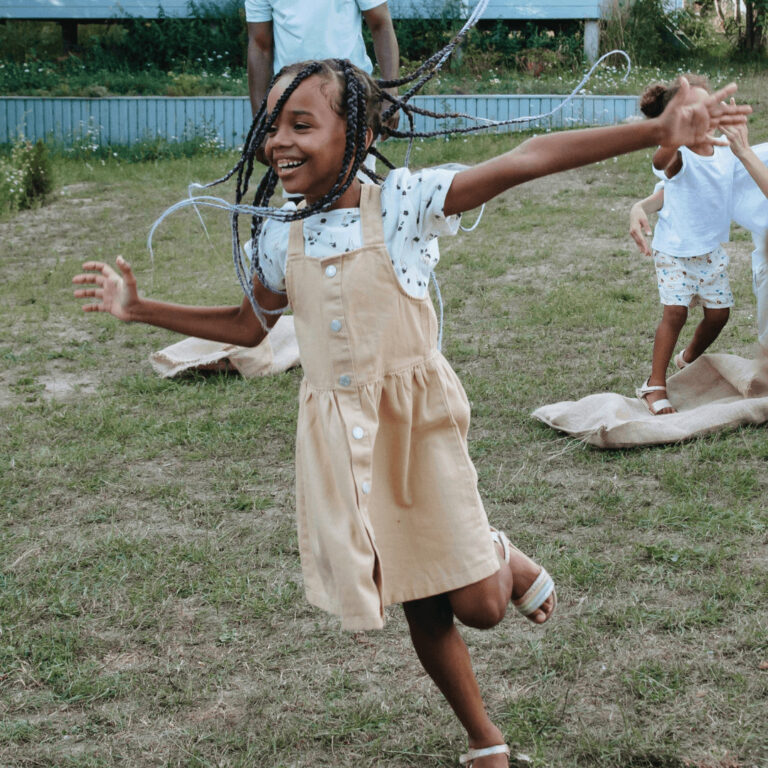 a girl running and enjoying her birthday