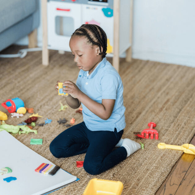 a kid playing with toys in the living room
