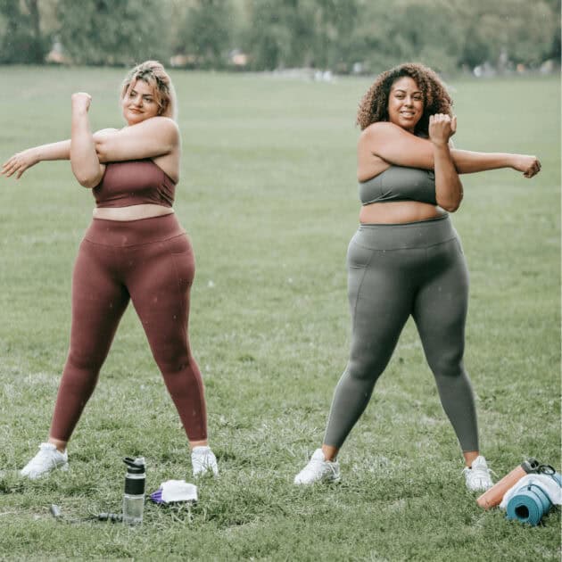 women working out wearing matching workout sets