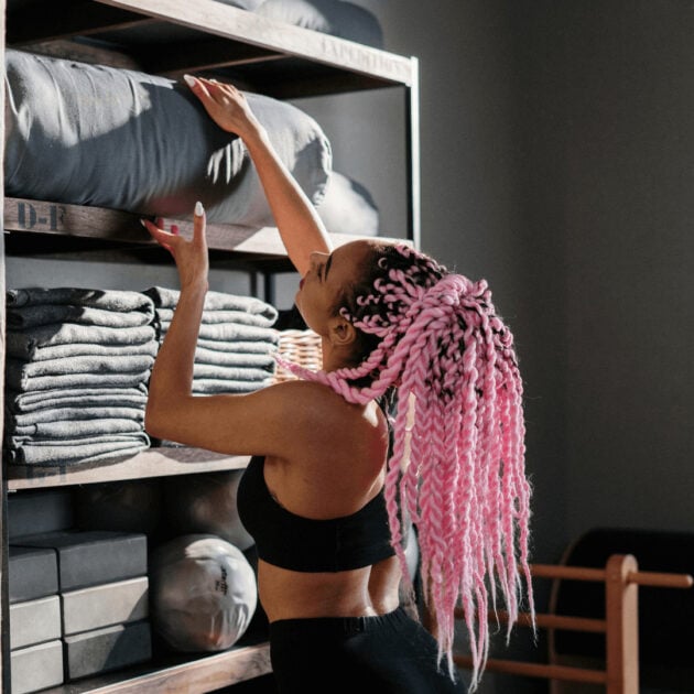 a woman organizing yoga props