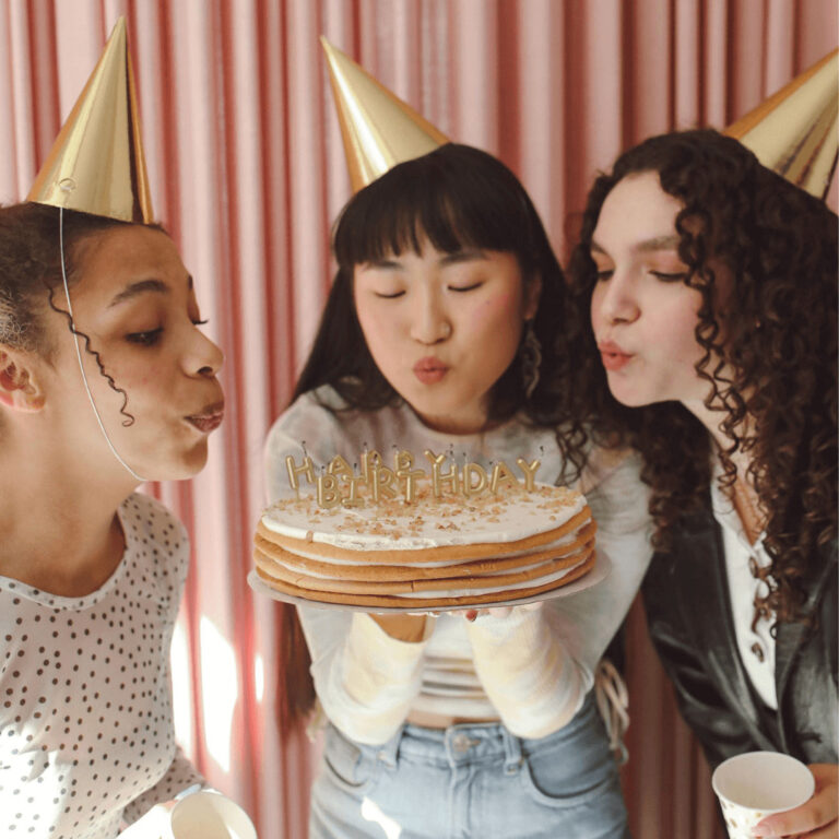 friends with a unique birthday cake