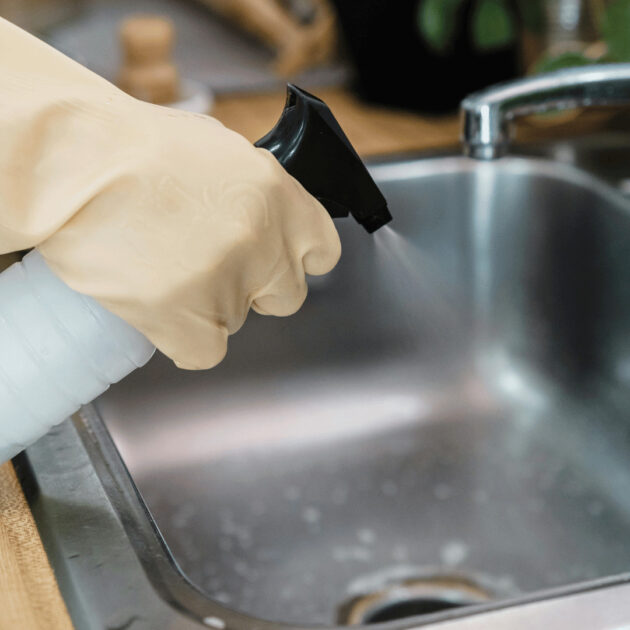 A spray bottle used to clean a kitchen sink
