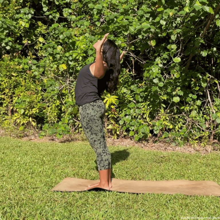 a woman doing a backbend with goal post arm variation
