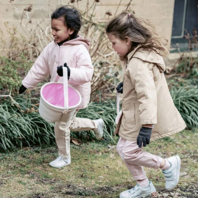 girls on a backyard Easter egg hunt