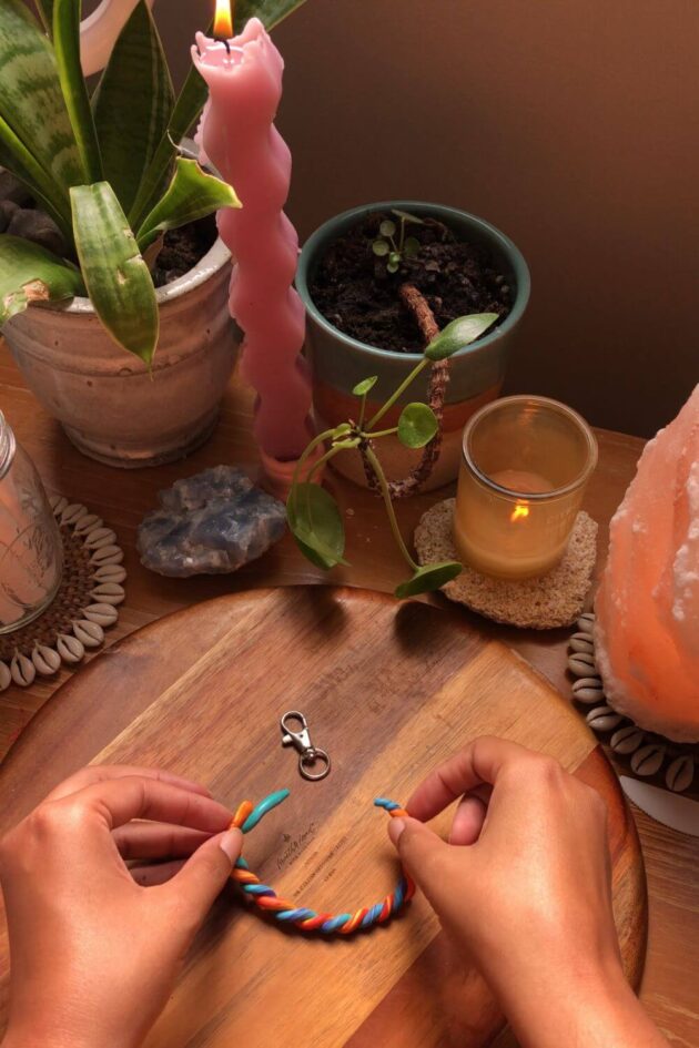 rainbow clay being shaped into a keychain