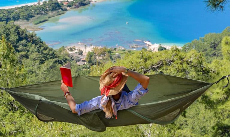 Person reading in hammock with scenic view