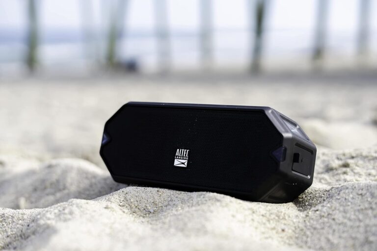 Portable speaker on sandy beach