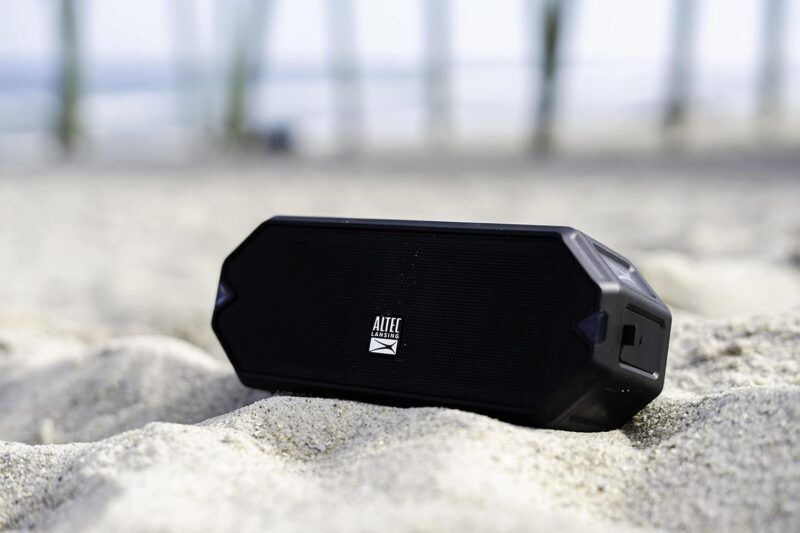 Portable speaker on sandy beach