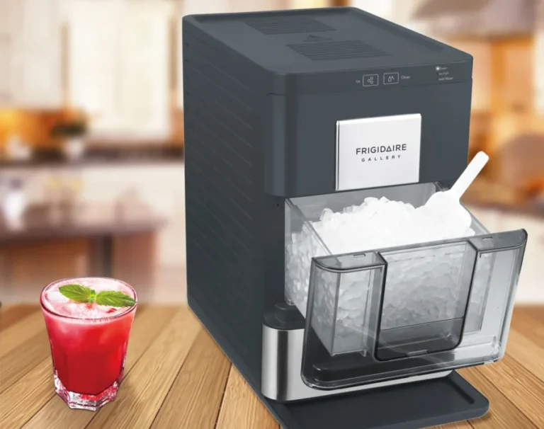 Frigidaire ice maker and red drink on table.