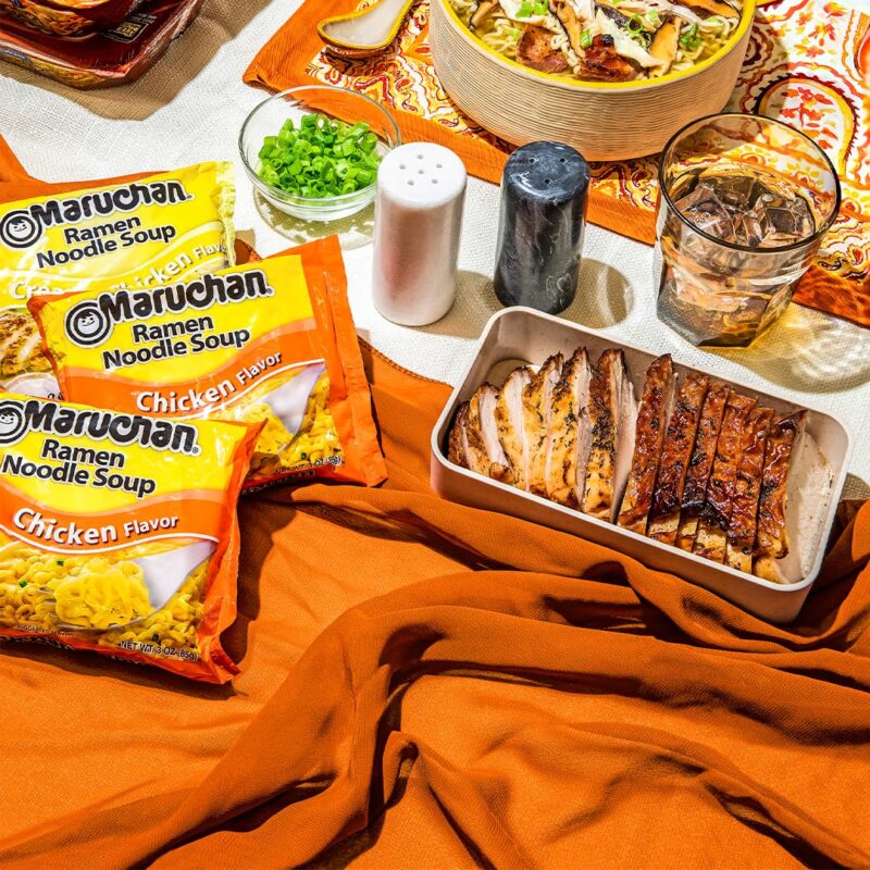 Maruchan ramen and chicken on decorative table.