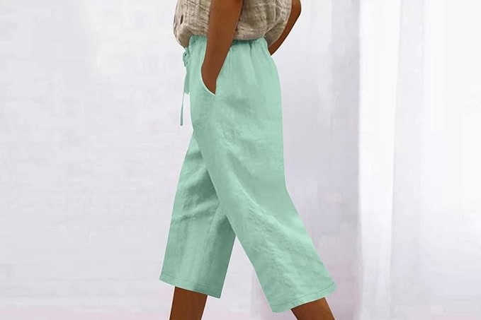 Woman wearing light green wide-leg pants.