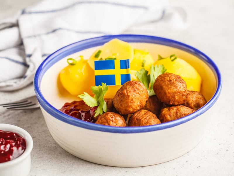 Swedish meatballs with potatoes and flag garnish.