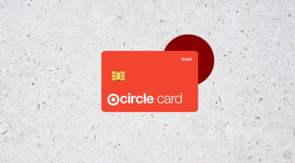 Red debit card with circle logo on surface