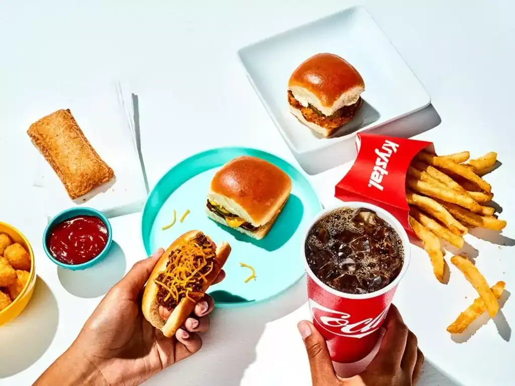 Fast food meal with fries and drinks.