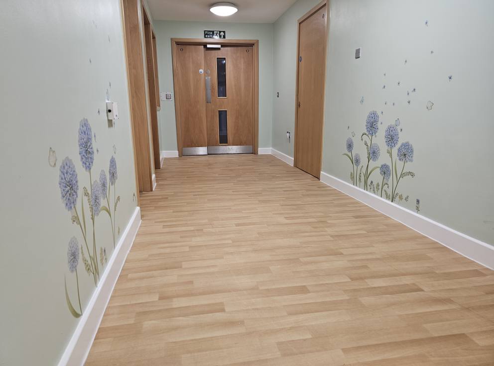 Hallway wall decoration with floral mural by professional decorators.