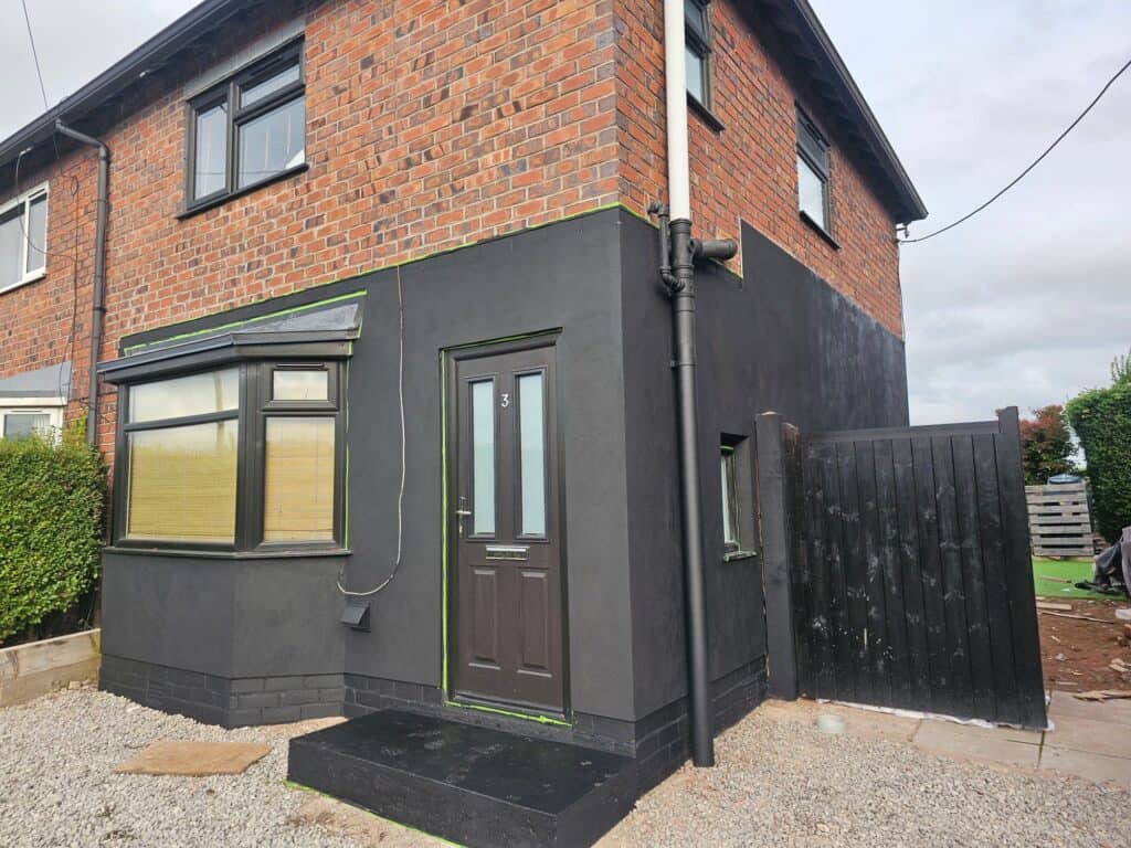 Exterior house painting with dark grey and brick finish by SWS Painters & Decorators.