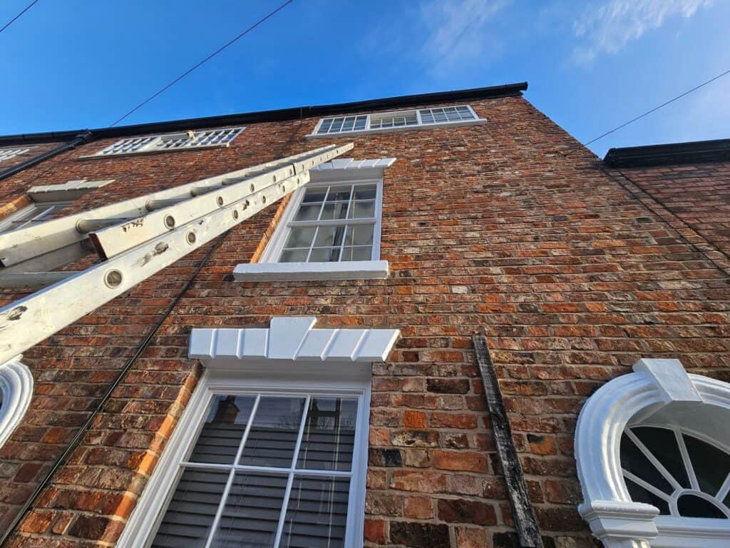 Exterior brick wall painting and decorating by professional painters and decorators.