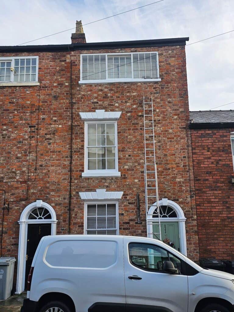 Exterior brick wall painting by SWS Painters & Decorators.