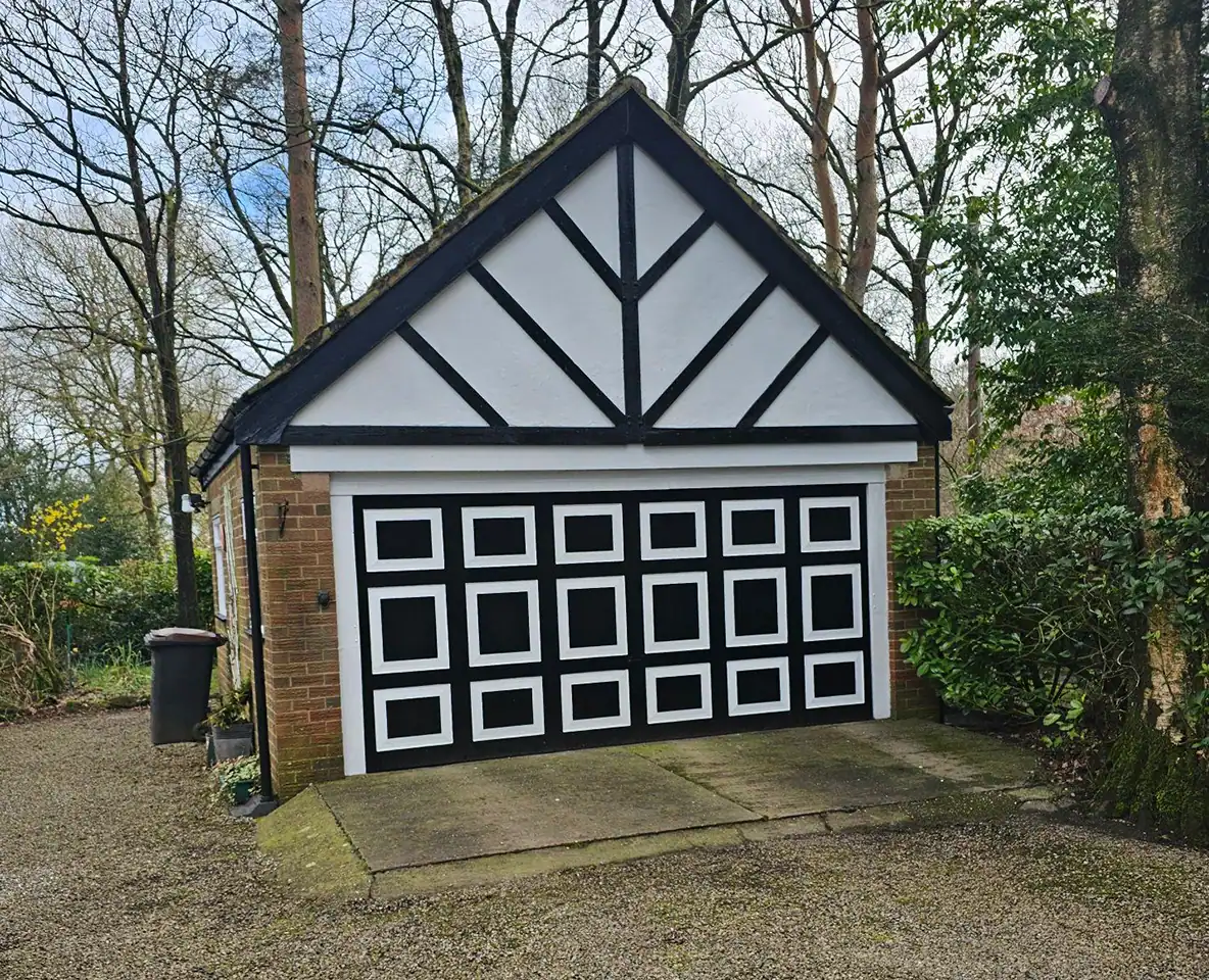 Garage door painted with black and white geometric design, enhancing curb appeal.