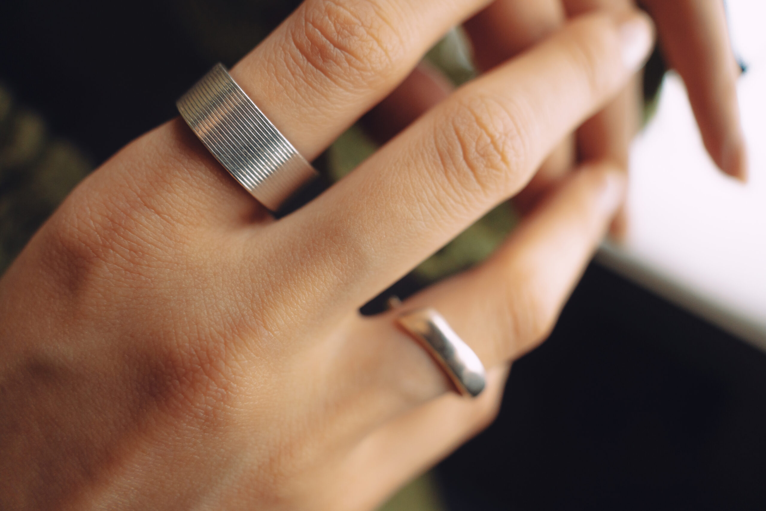 Close focus of a hand with two rings.
