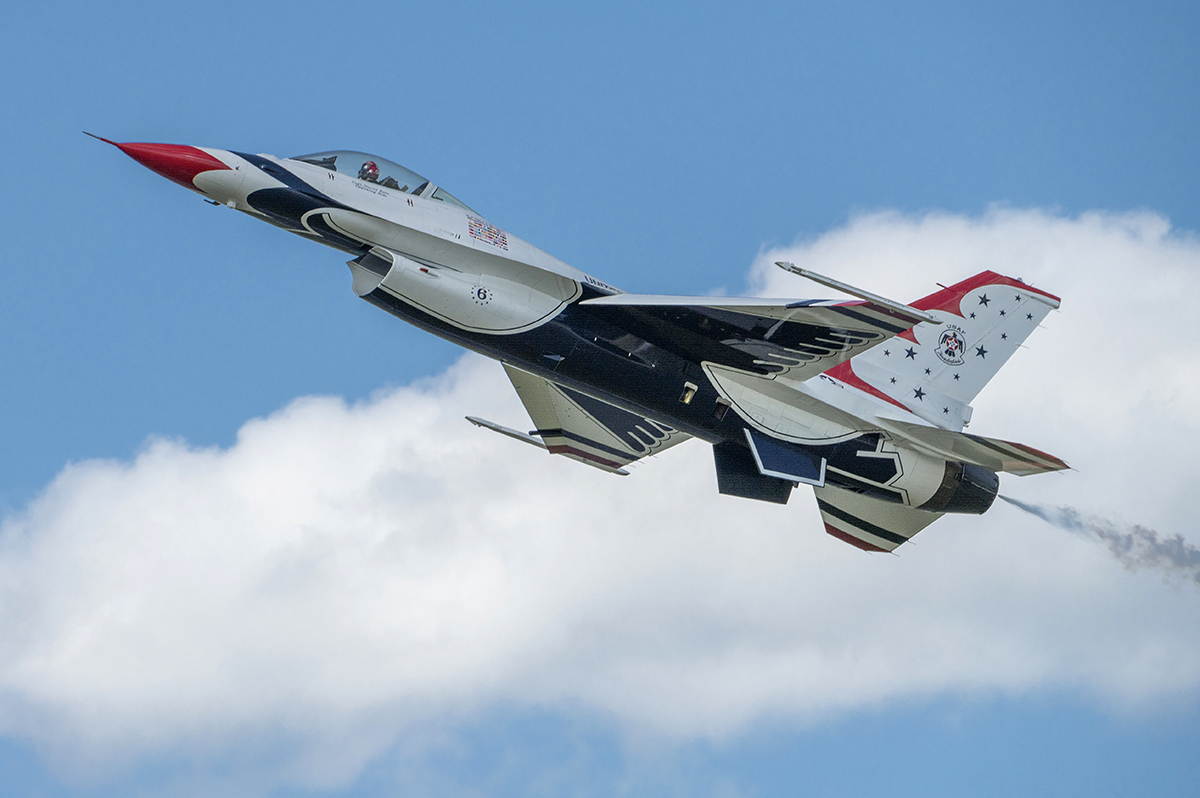 Close-up of a USAF Thunderbird jet soaring through the sky, showcasing the precision and clarity achievable with Tamron lenses for airshow photography.