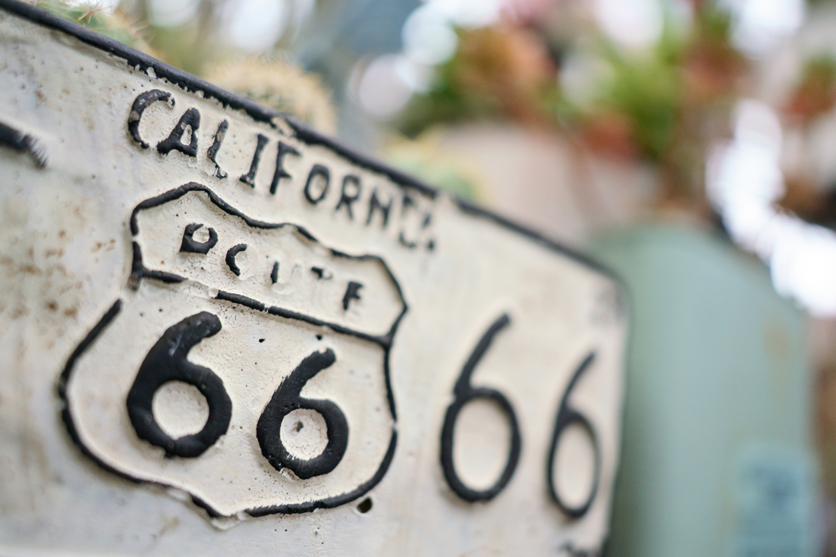 A close-up image of a vintage California Route 66 sign, highlighting surface texture and depth&mdash;an example of how to photograph close-up images with shallow depth-of-field. &copy;Takashi Namiki