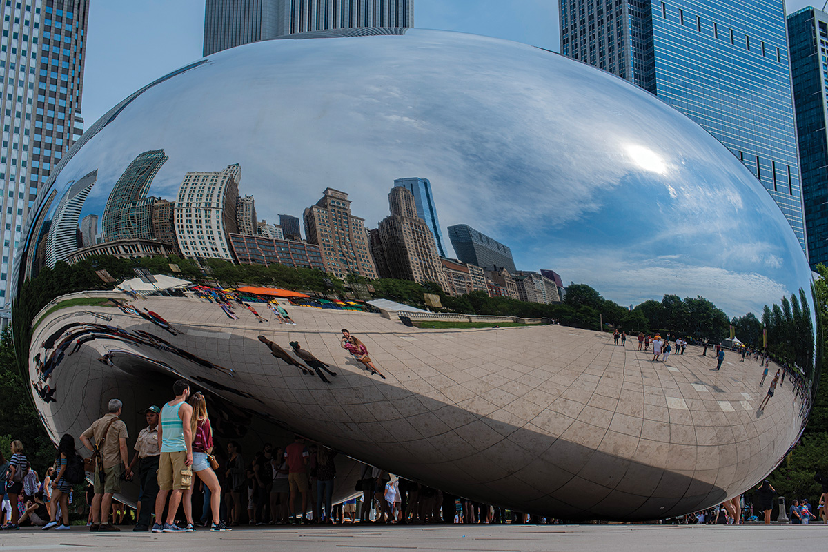 Reflections of people in the Bean in Chicago, IL