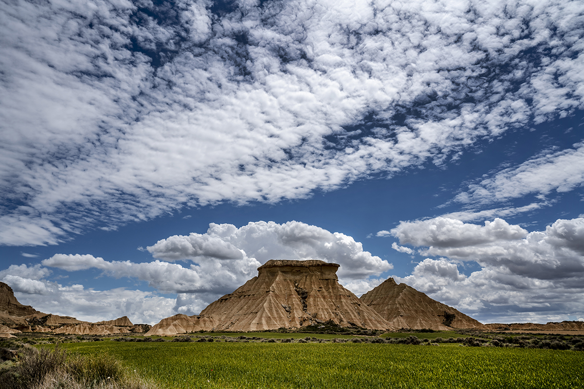Dramatic desert landscape under a polarized sky.
