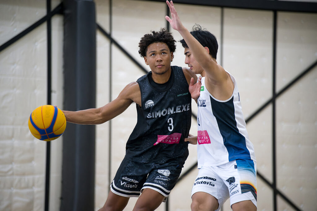 Two basketball players in action during a game.