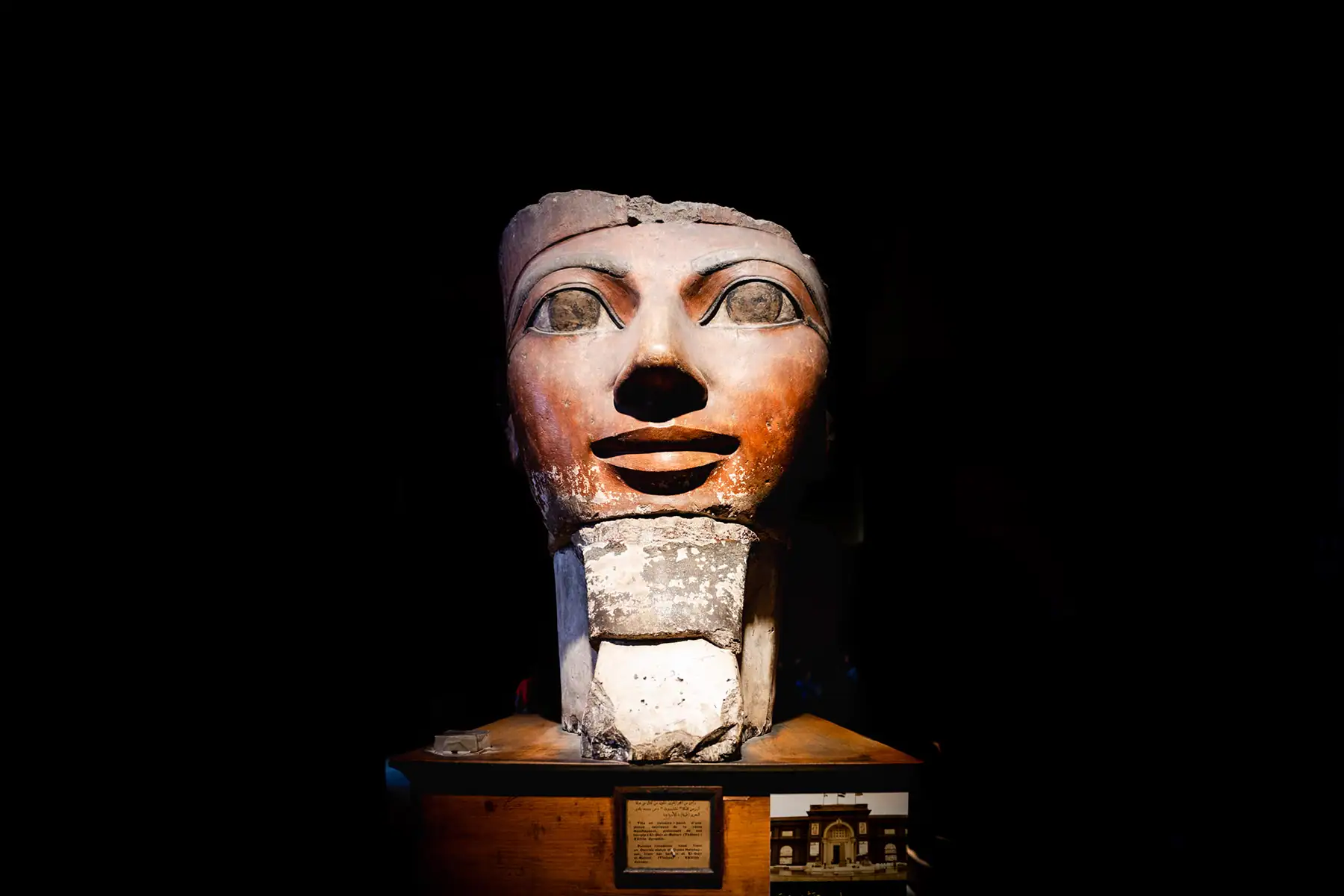 Ancient Egyptian sculpture of a pharaoh's head on display at the Egyptian Museum in Cairo, a must-see site when you photograph historical landmarks in Egypt.