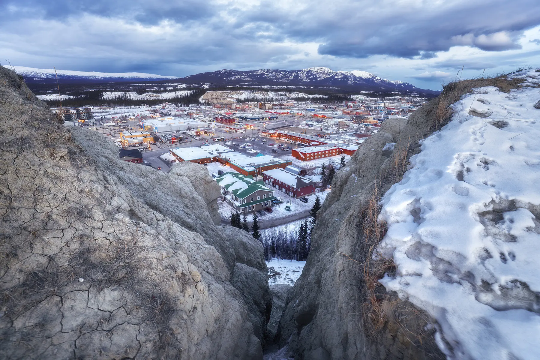 During the Tamron 16-30mm field test, this dramatic wide-angle view from a snowy cliff edge captures the town of Whitehorse nestled in the Yukon landscape, showcasing the lens&rsquo;s perspective distortion and edge-to-edge clarity.