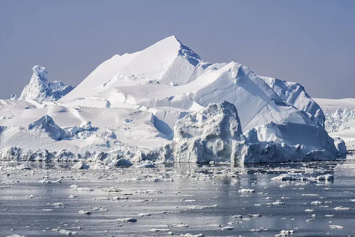 Majestueux iceberg dans le fjord glaciaire d'Ilulissat, au Groenland, s'élevant nettement au-dessus des eaux arctiques et photographié avec un zoom Tamron.