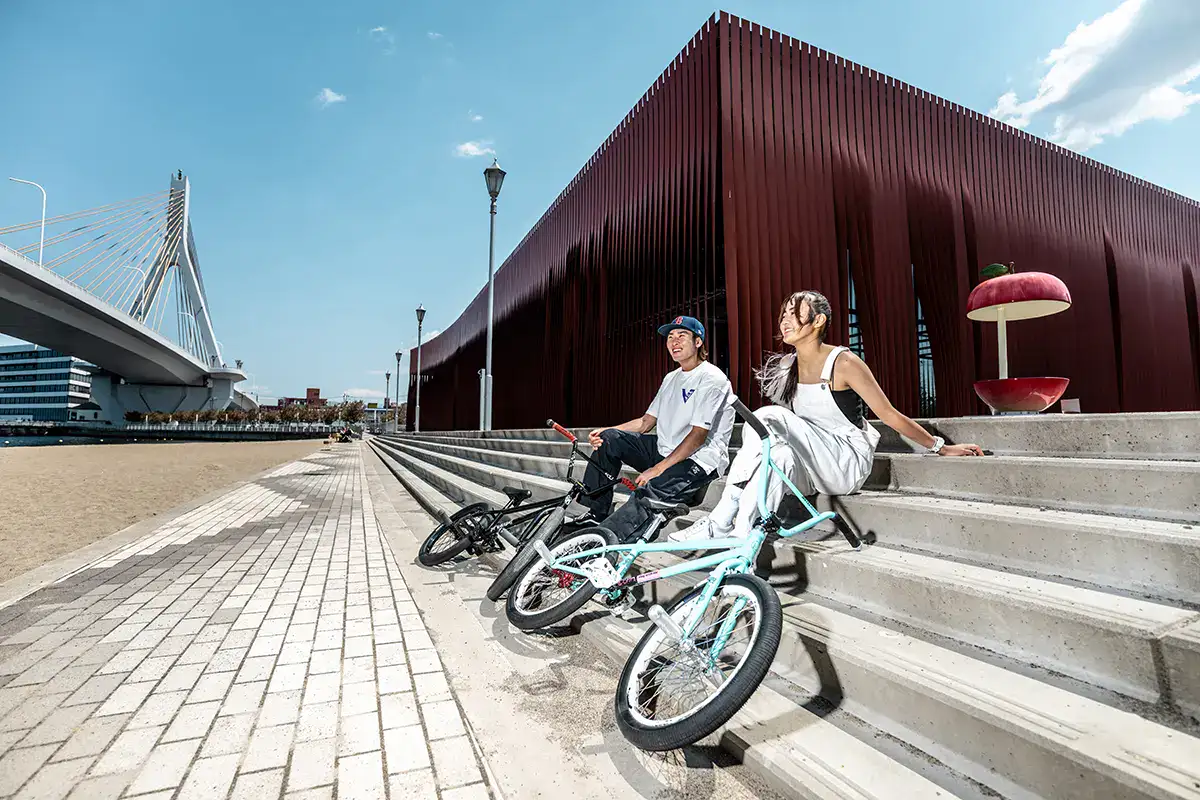 Urban sports photography featuring BMX riders relaxing near Wa Rasse cultural center in Aomori, Japan.