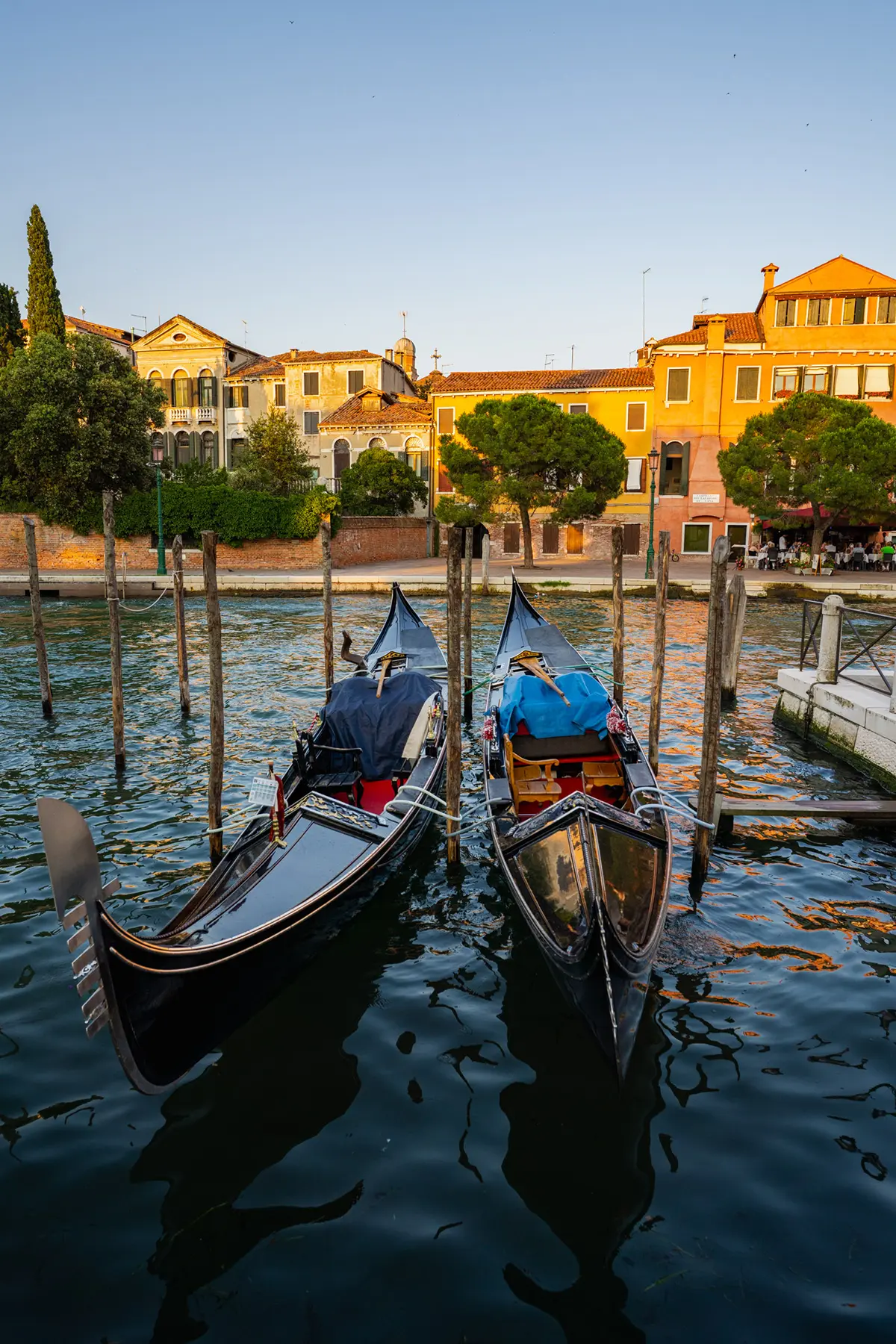 Two gondolas docked along a quiet Venetian canal at golden hour, captured for this Venice travel photography guide.