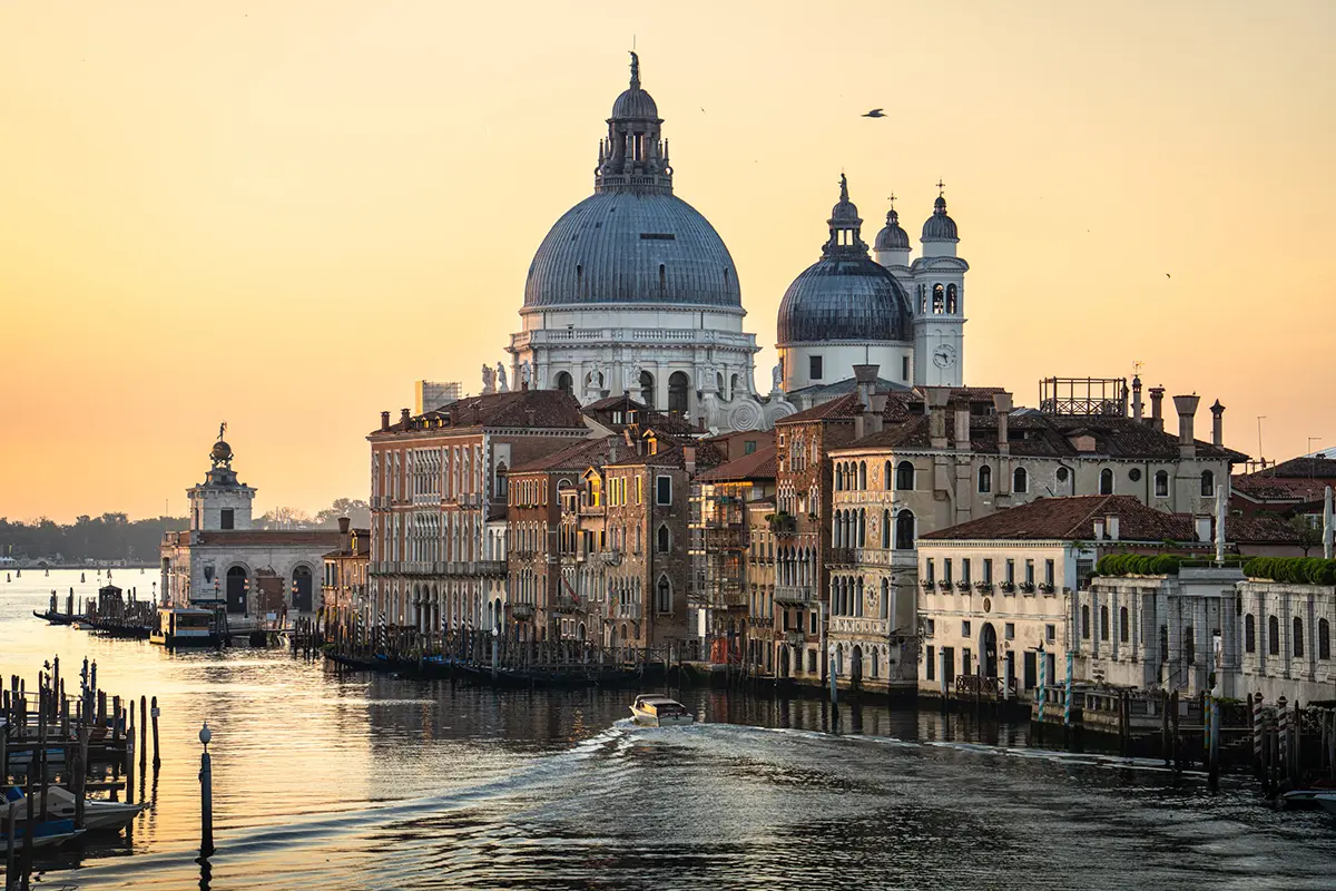 Sunrise view of the Basilica di Santa Maria della Salute from Ponte dell&rsquo;Accademia, featured in this Venice travel photography guide.