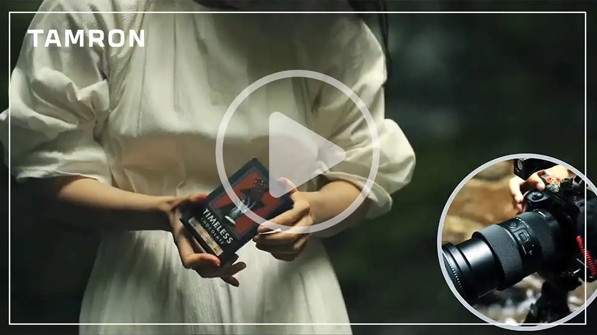 Thumbnail for a video demonstrating the Focus Preset feature using the TAMRON Lens Utility, showing a woman holding a product and a close-up of a camera with a TAMRON lens.