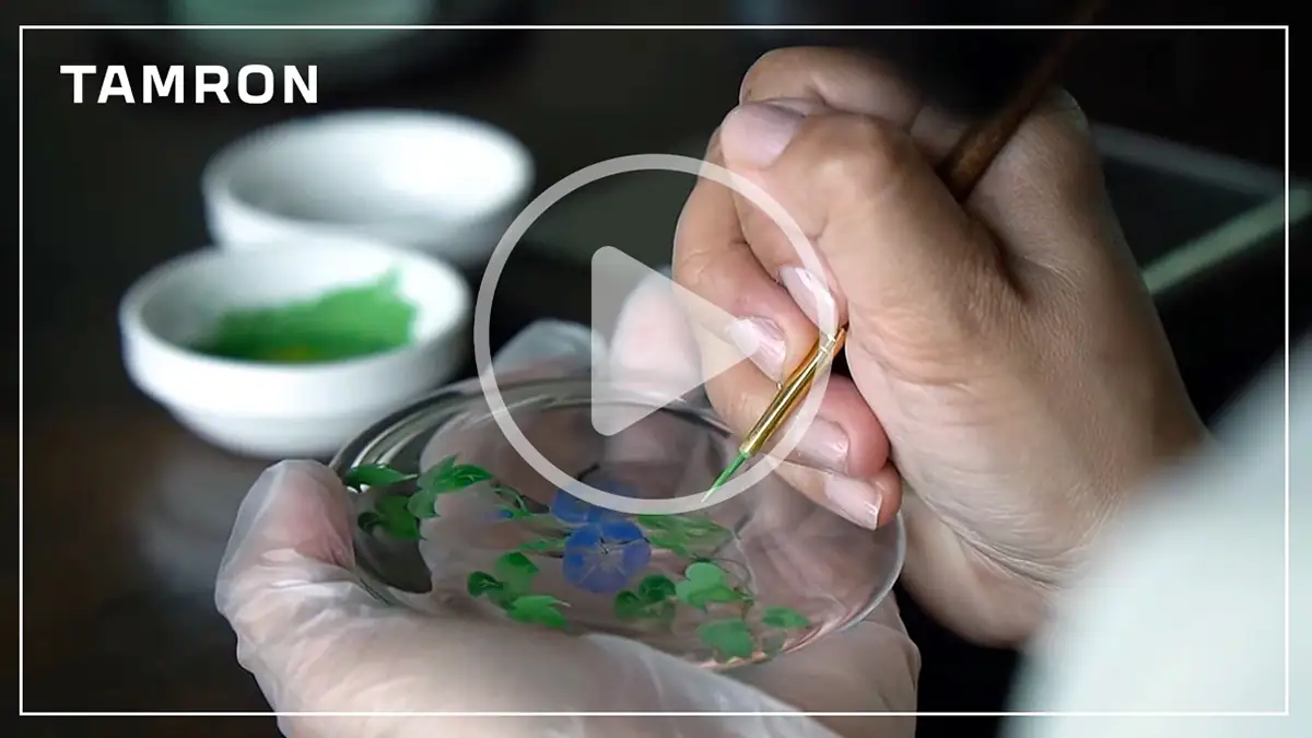 Video thumbnail of a close-up of artistic hand-painting filmed while shooting video with a mirrorless camera, capturing fine detail and color for creative content.