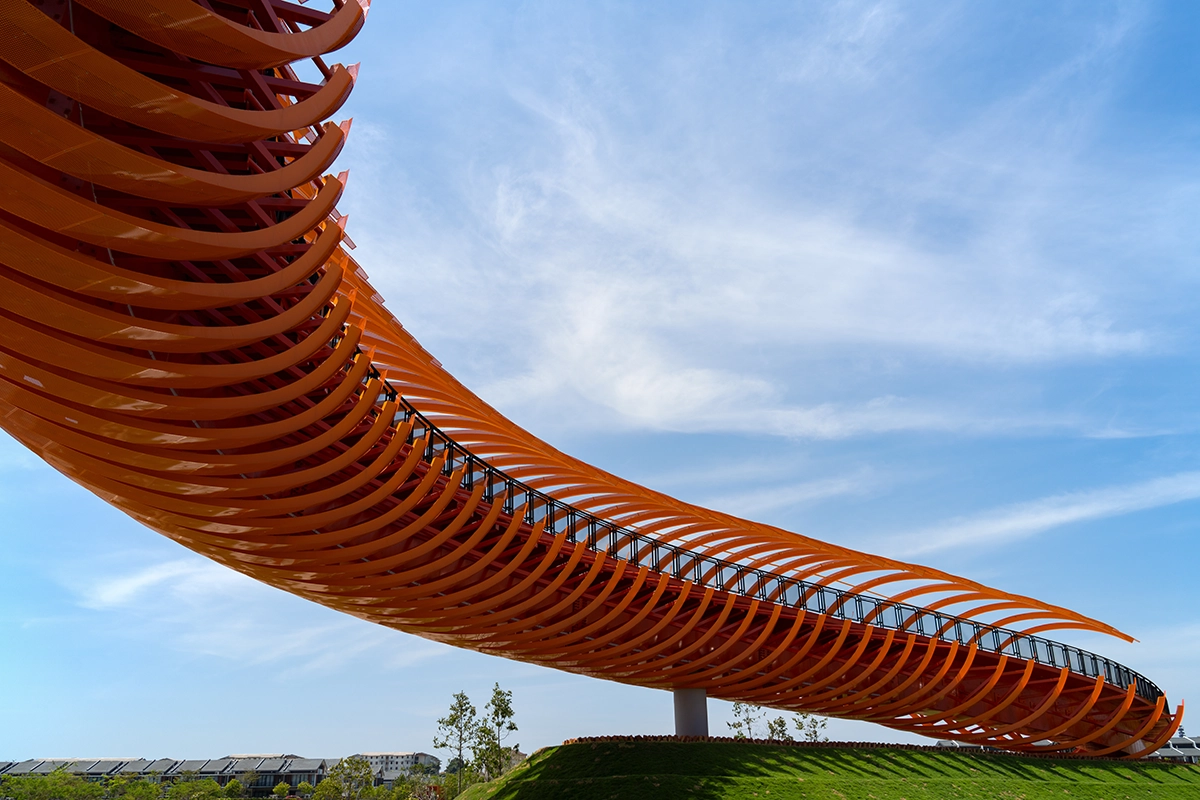 Curved orange architectural structure against a blue sky, demonstrating curved composition in photography.