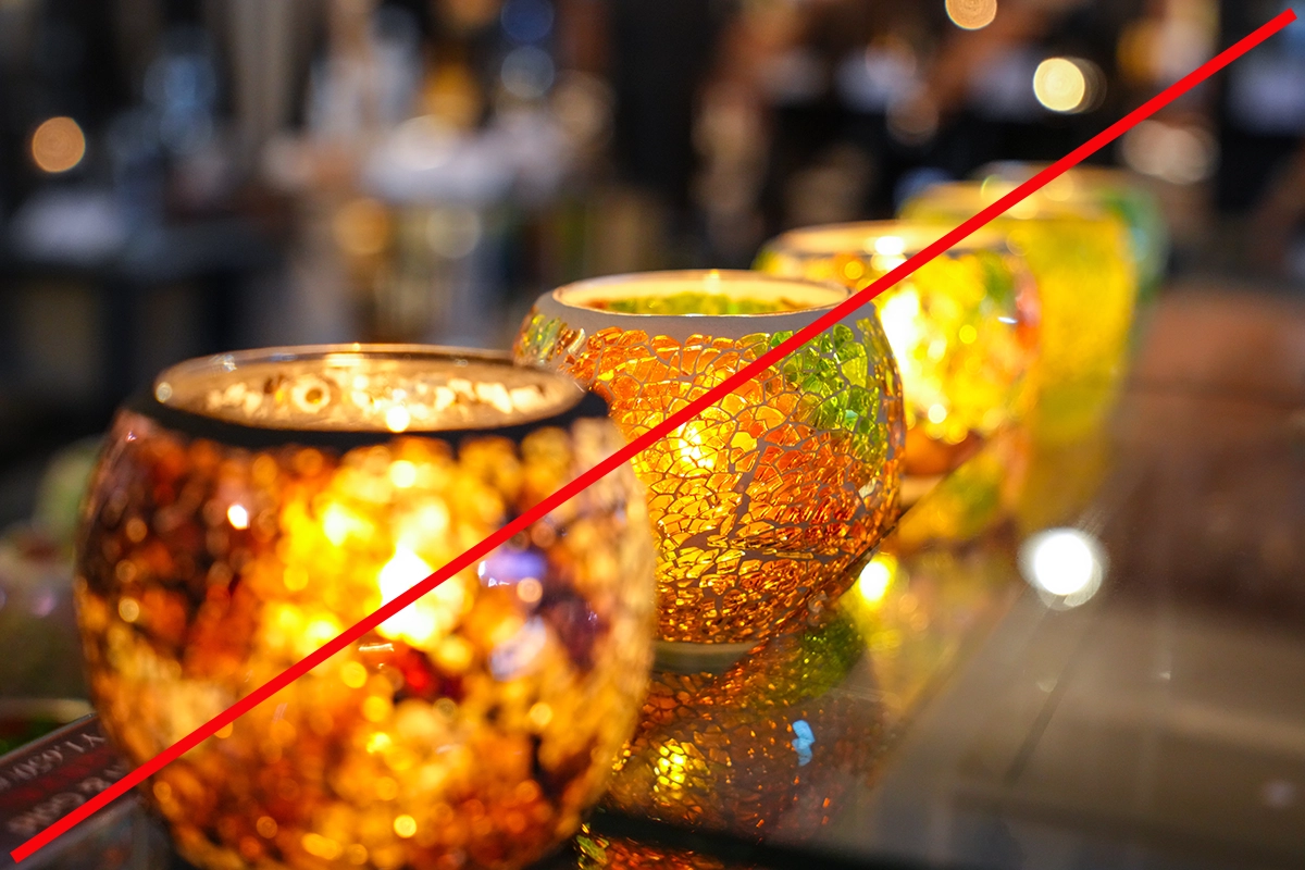 Row of colorful mosaic candle holders with a red diagonal line overlay, demonstrating diagonal composition.