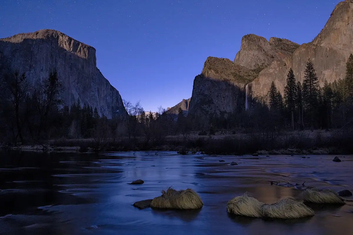 Mountain landscape with lake and twilight sky at blue hour.