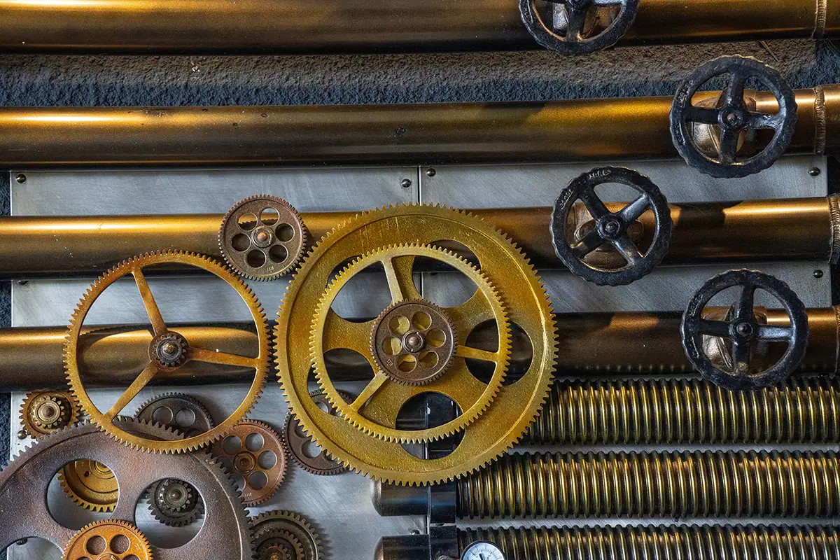 Close-up of industrial gears, valves, and metal textures in Indonesia, photographed as an abstract travel detail with the Tamron 70-180mm F2.8 G2 lens.